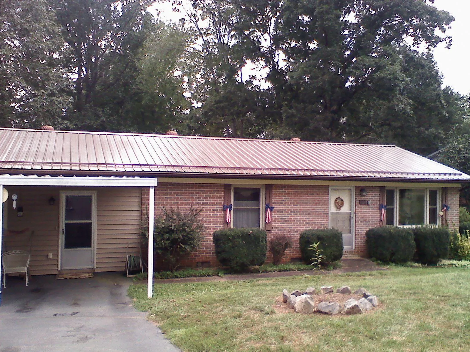 Bronze metal roof and carport on a brick ranch home — Roof Repair work by our crew in Marlboro