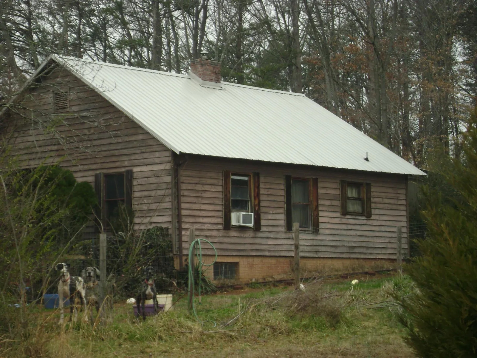 White metal roof on an old wood sided farmhouse, from a Metal Roof Installation job in Marlboro